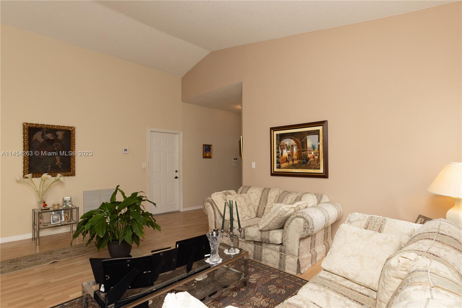 10067 Southwest 156th Avenue Miami, FL 33196 - Photo 20 of 21 a living room with furniture flowerpot and wooden floor
