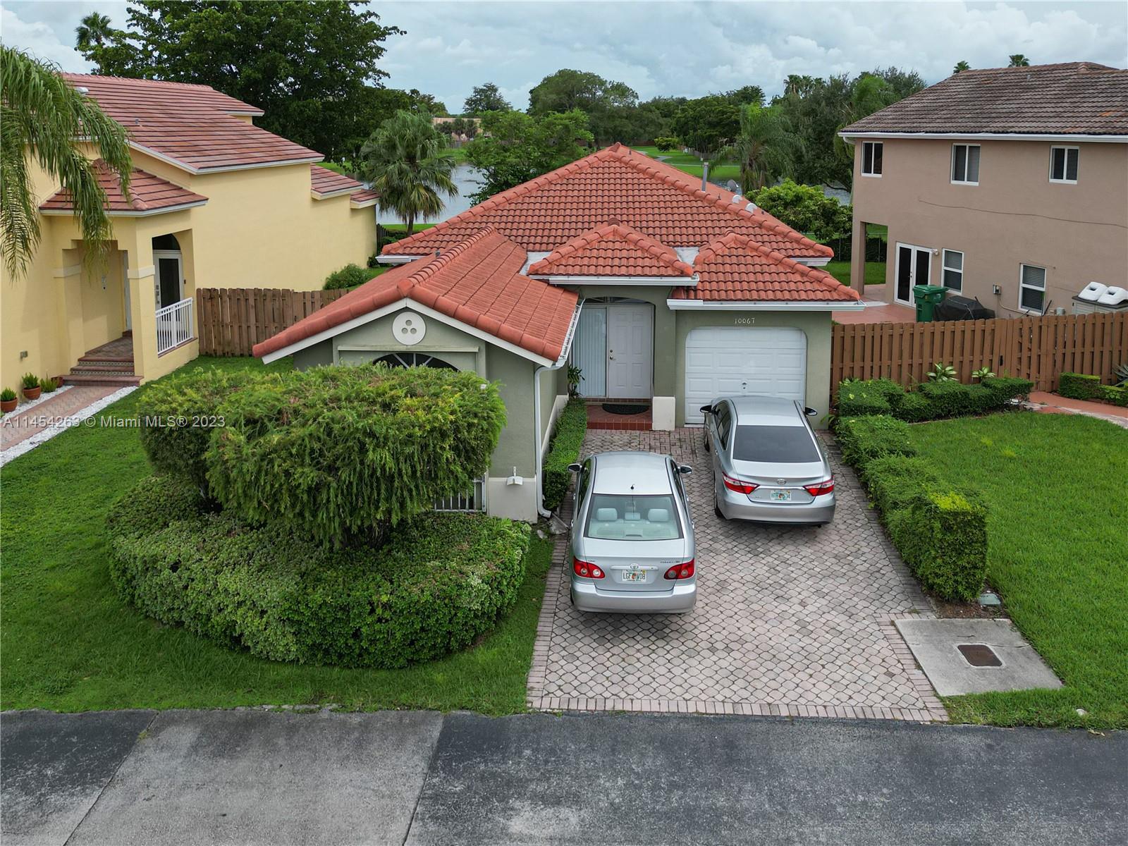 10067 Southwest 156th Avenue Miami, FL 33196 - Photo 2 of 21 a view of house with garden and parking space