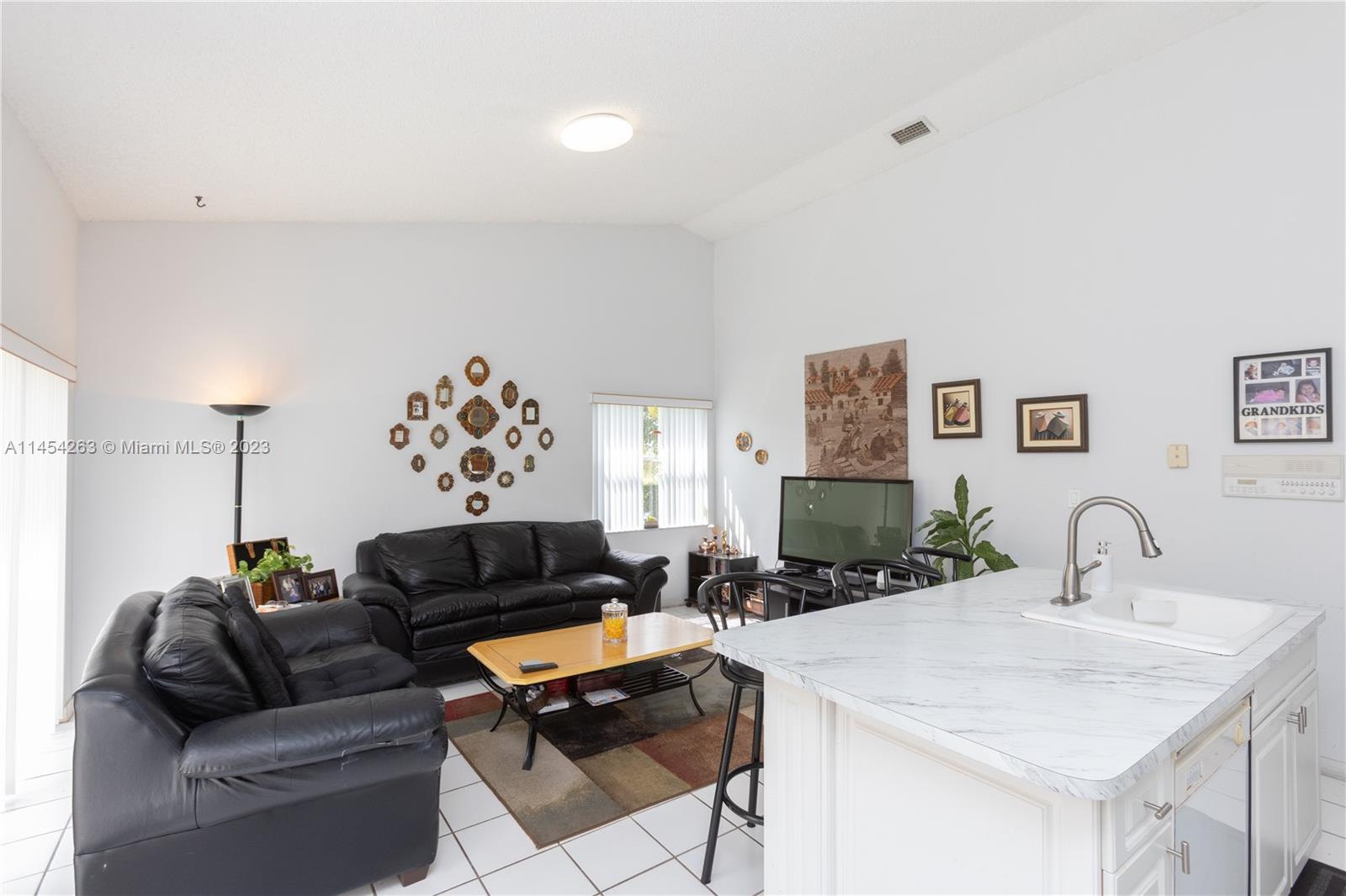 10067 Southwest 156th Avenue Miami, FL 33196 - Photo 4 of 21 a living room with furniture and a flat screen tv