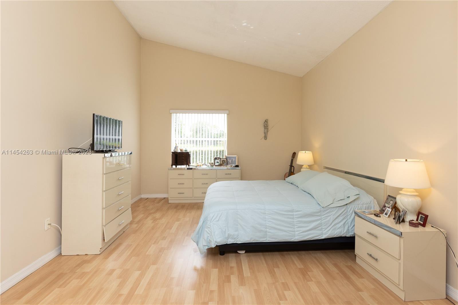 10067 Southwest 156th Avenue Miami, FL 33196 - Photo 6 of 21 a bedroom with a bed and wooden floor