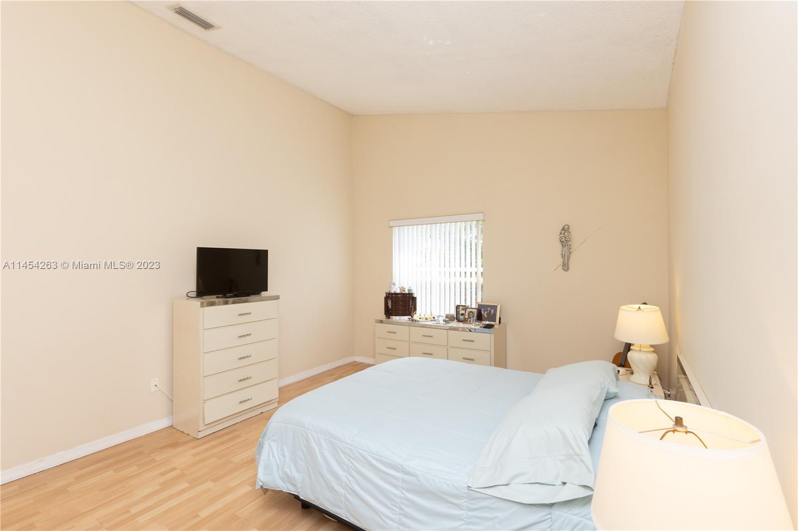 10067 Southwest 156th Avenue Miami, FL 33196 - Photo 7 of 21 a bedroom with a bed and a flat screen tv