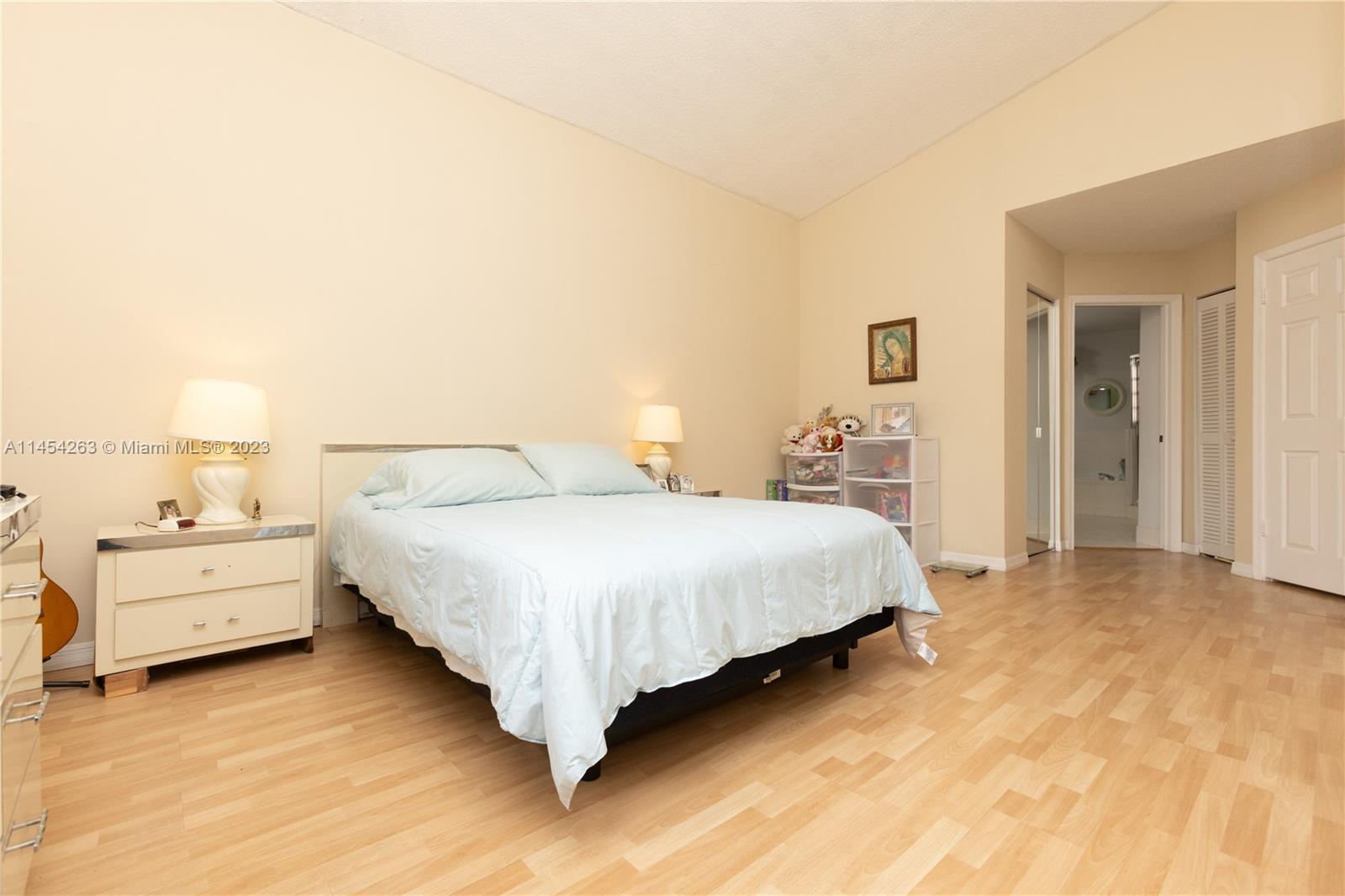 10067 Southwest 156th Avenue Miami, FL 33196 - Photo 8 of 21 a bedroom with a bed and a night stand