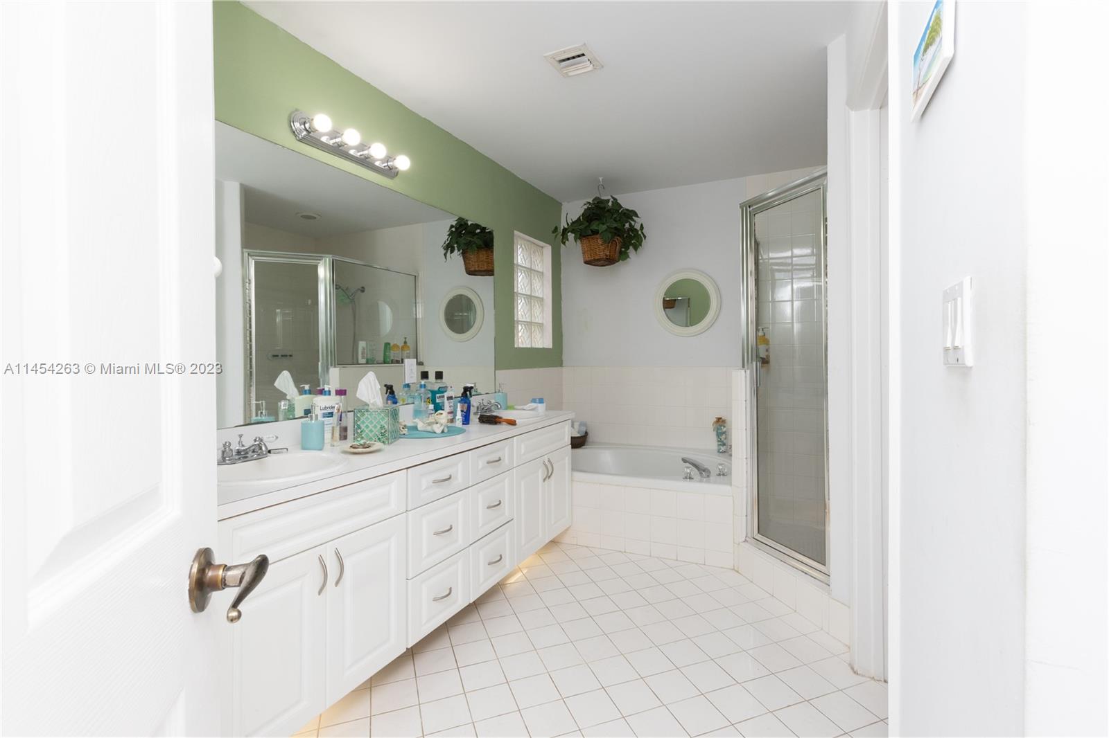 10067 Southwest 156th Avenue Miami, FL 33196 - Photo 9 of 21 a bathroom with a bathtub a sink and a mirror