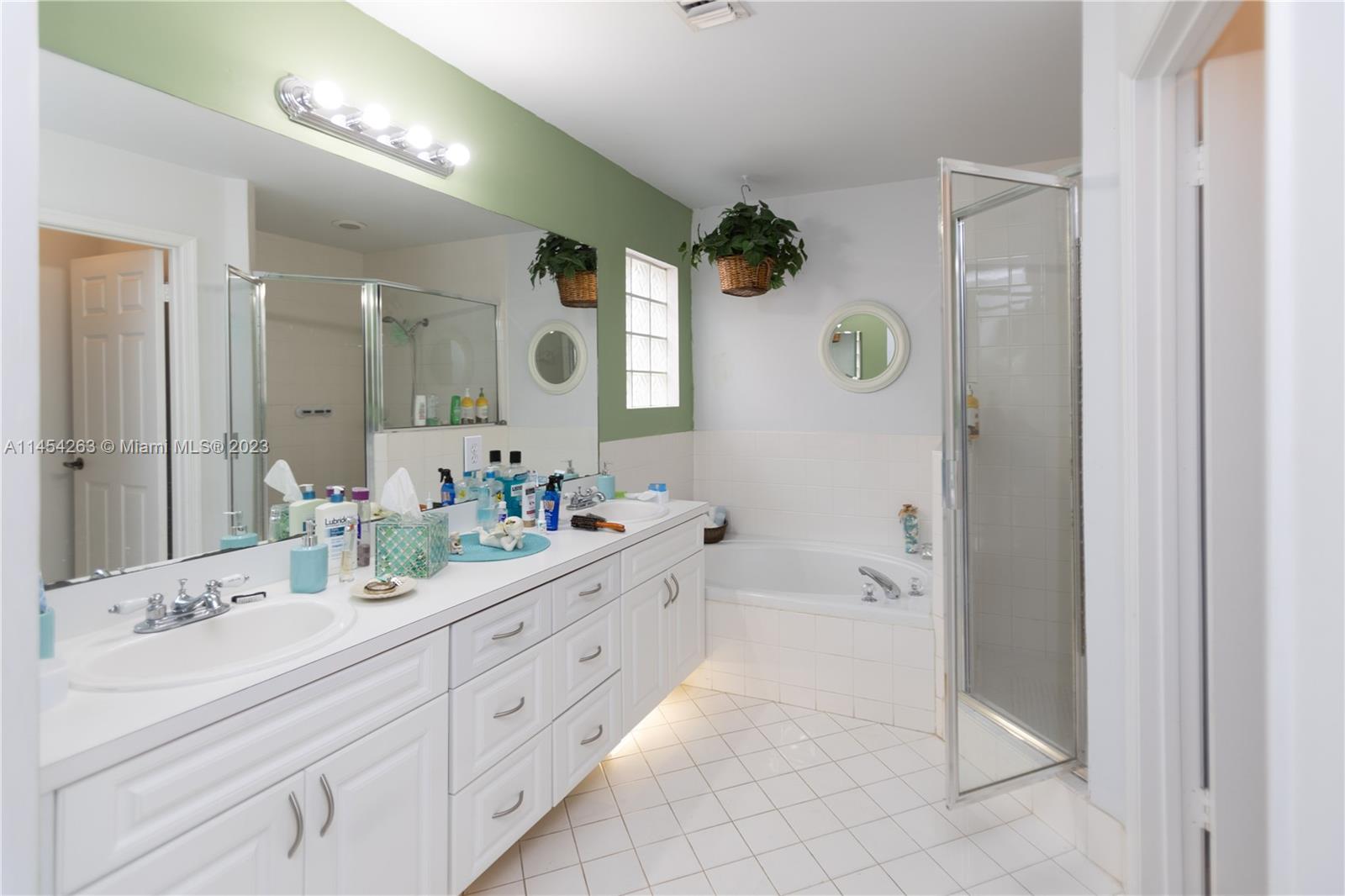 10067 Southwest 156th Avenue Miami, FL 33196 - Photo 10 of 21 a spacious bathroom with a granite countertop sink a mirror and a shower