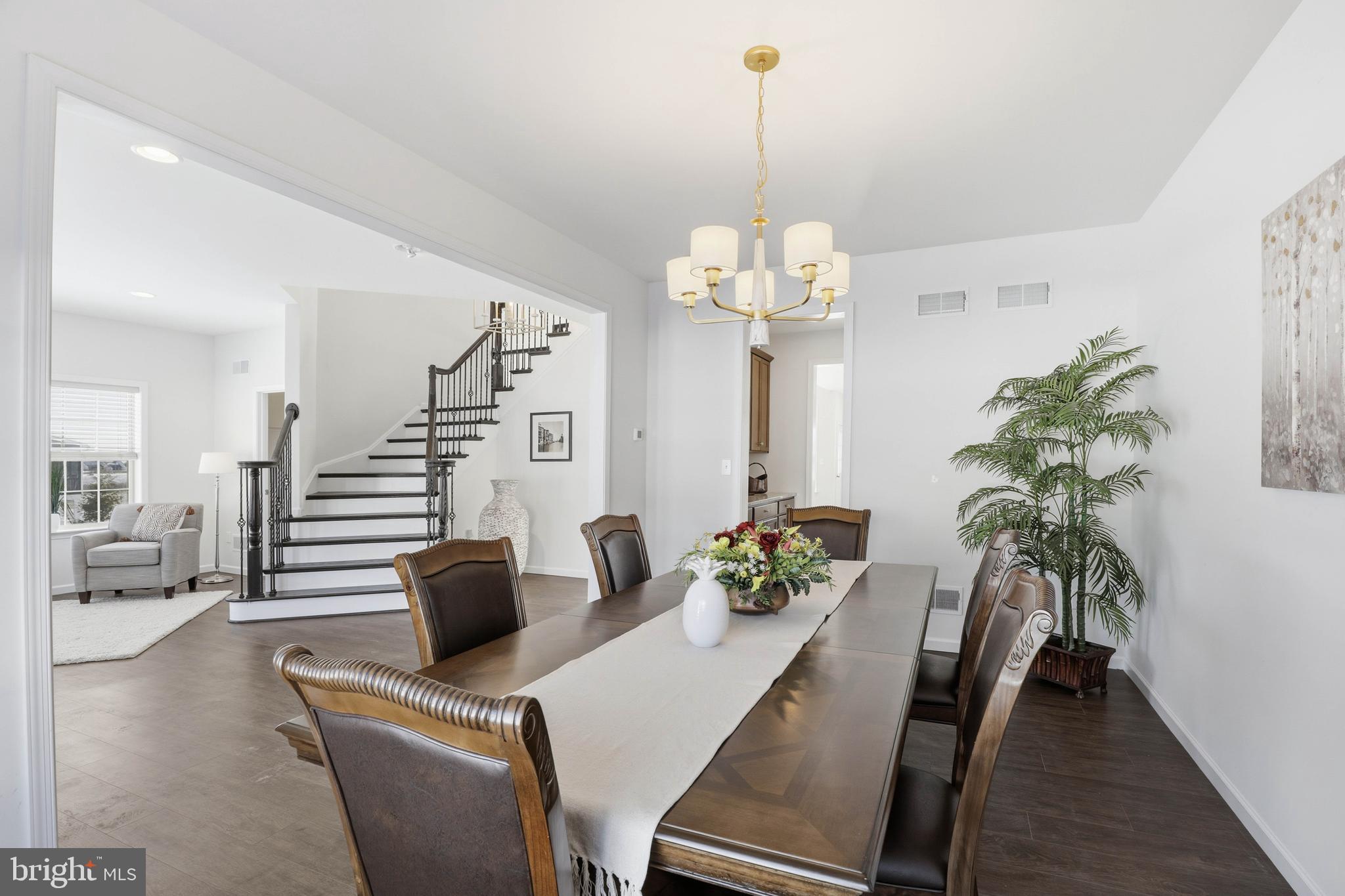 454 East Delp Road Lancaster, PA 17601 - Photo 12 of 78 a view of a dining room and livingroom with furniture wooden floor a chandelier