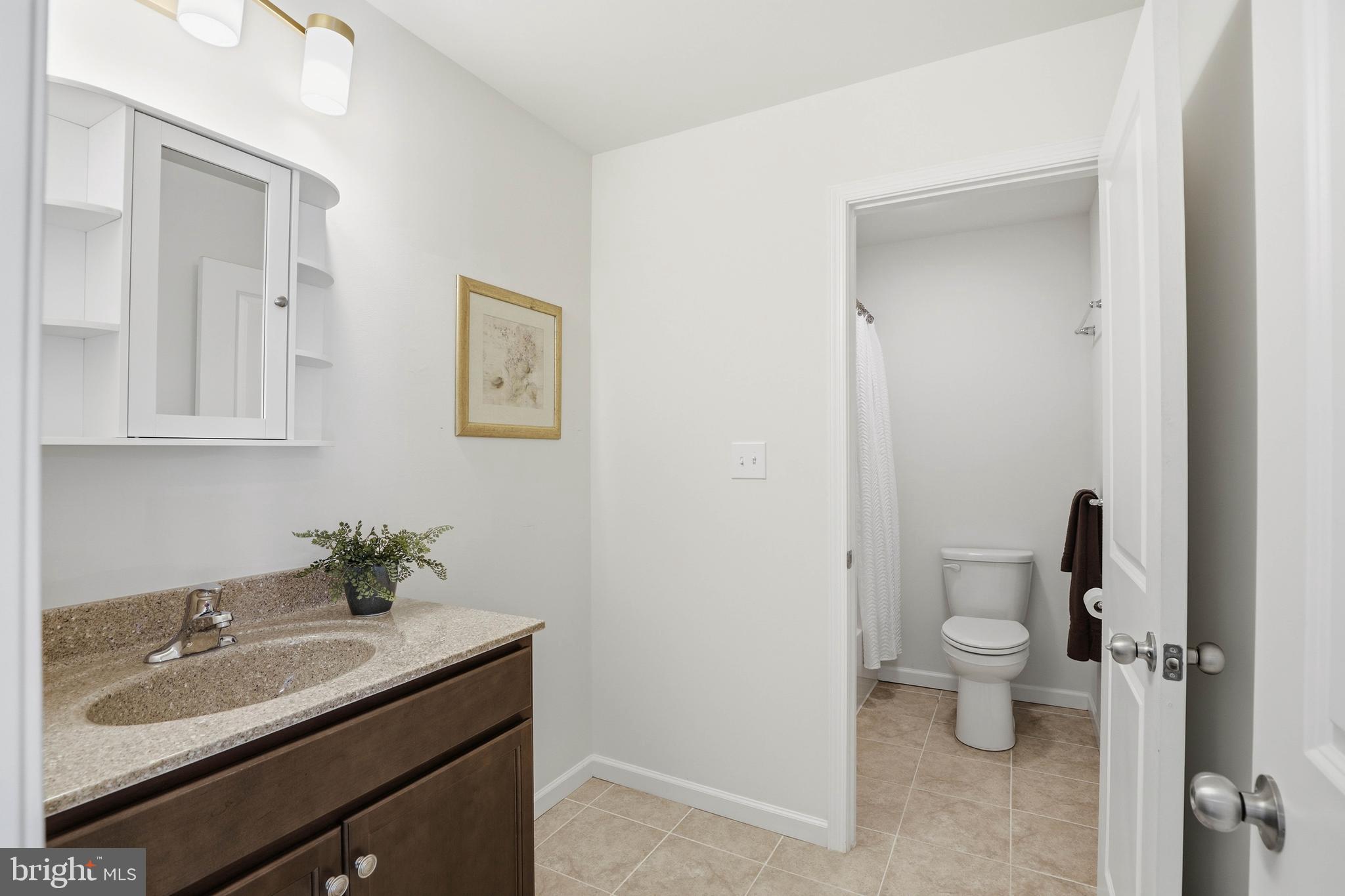 454 East Delp Road Lancaster, PA 17601 - Photo 51 of 78 a bathroom with a granite countertop sink a toilet and a mirror