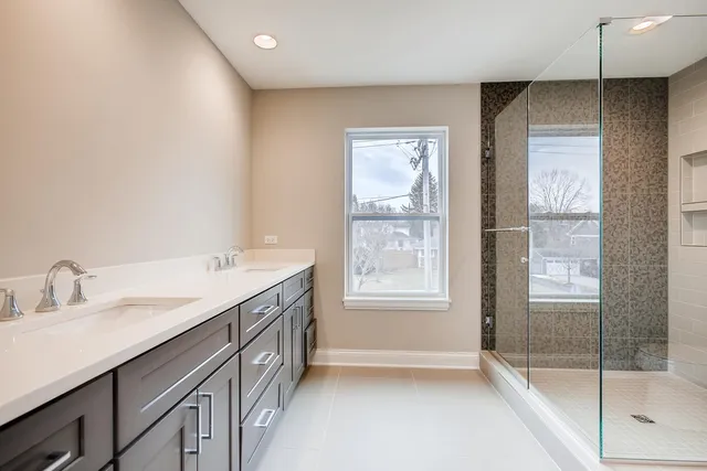 a bathroom with a sink a vanity and a shower
