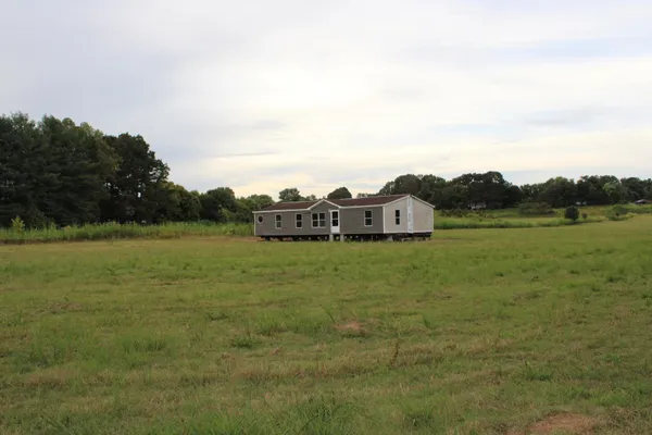 a view of a field with an ocean