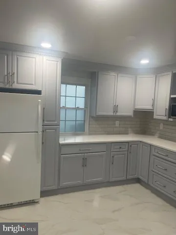 a kitchen with sink cabinets and stainless steel appliances