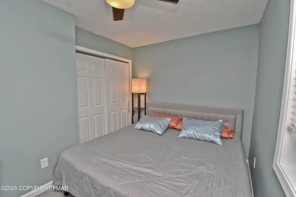 a bedroom with a bed and a window