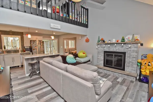 a living room with furniture a fireplace and a chandelier