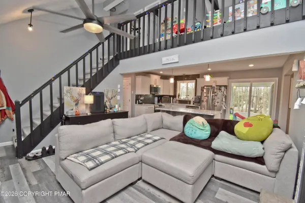 a living room with furniture and a dining table