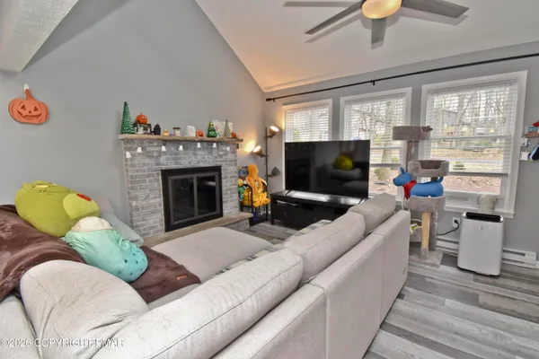 a living room with furniture fireplace and flat screen tv