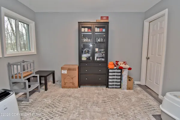 a view of a bedroom with furniture and window