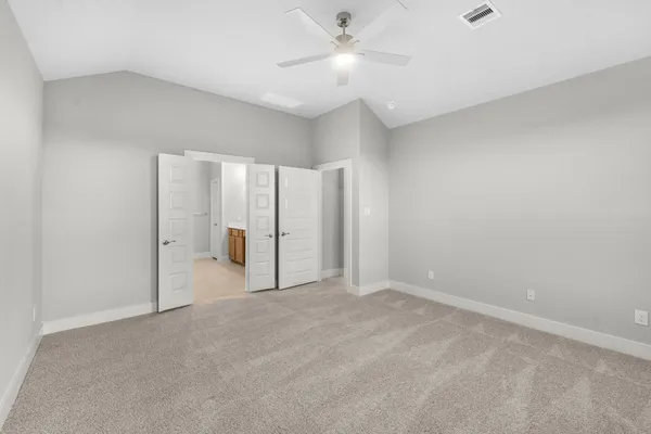 a view of an empty room with a ceiling fan