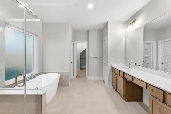 a large bathroom with a double vanity sink a large mirror and a shower