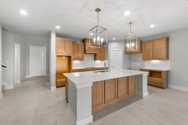 a large kitchen with kitchen island a sink stainless steel appliances and cabinets