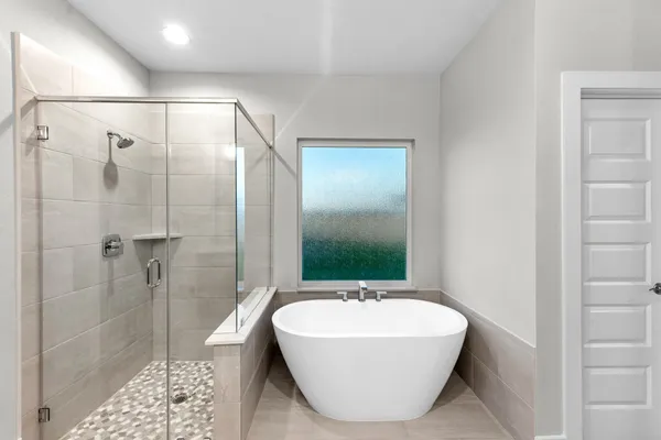 a bathroom with a bathtub and shower