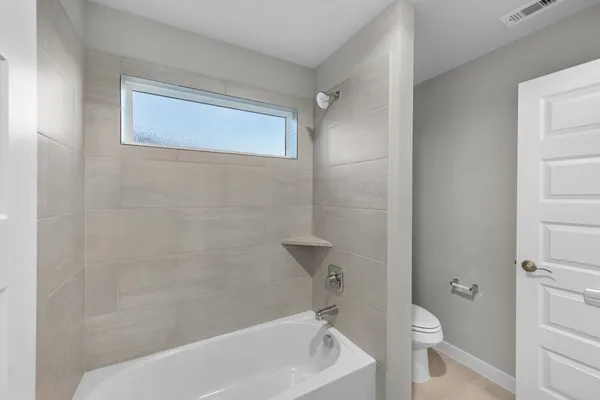 a bathroom with a bathtub and a toilet