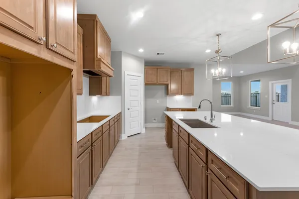 a kitchen with stainless steel appliances a sink stove and cabinets