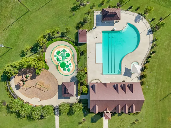 an aerial view of a house with outdoor space and a lake view