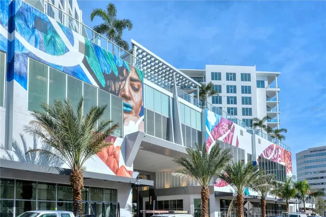 a front view of a multi story building with yard