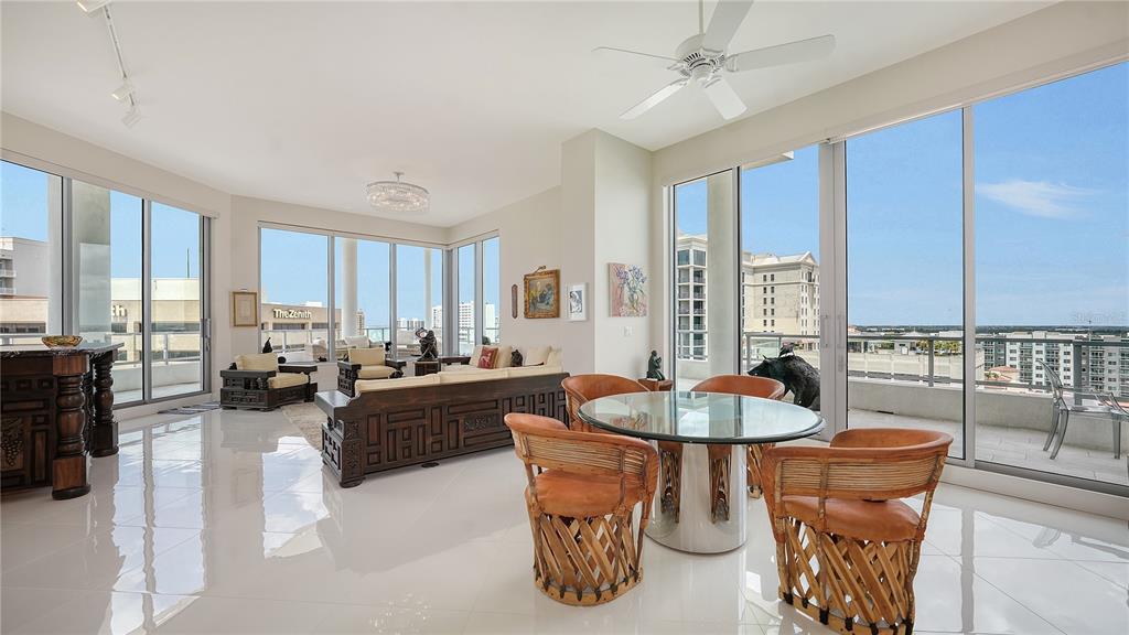 111 South Pineapple Avenue, Unit 1210 Sarasota, FL 34236 - Photo 15 of 54 a living room with patio furniture and a chandelier