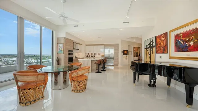 a living room with furniture large window and flat screen tv