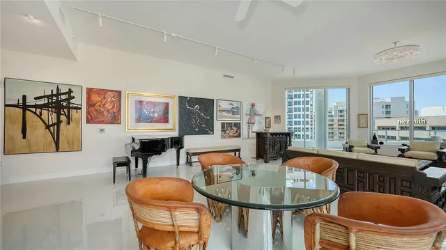 a dining room with furniture a rug and a chandelier