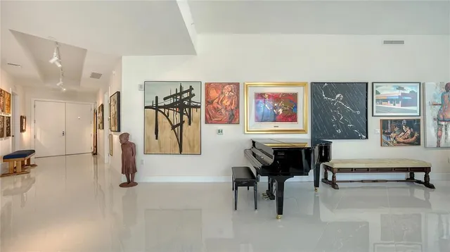 a living room with furniture and paintings on the wall