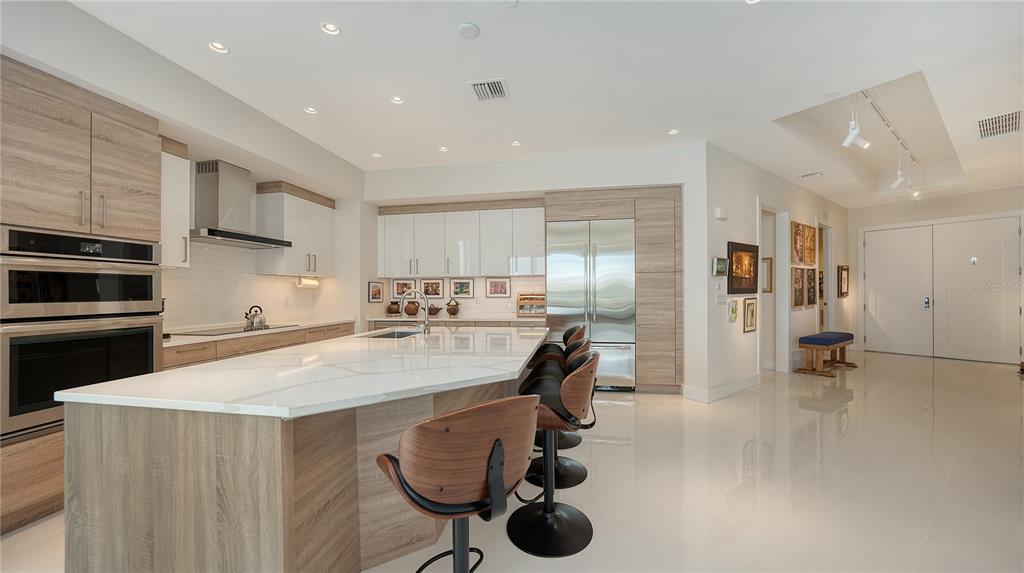 111 South Pineapple Avenue, Unit 1210 Sarasota, FL 34236 - Photo 30 of 54 a kitchen with a table and chairs