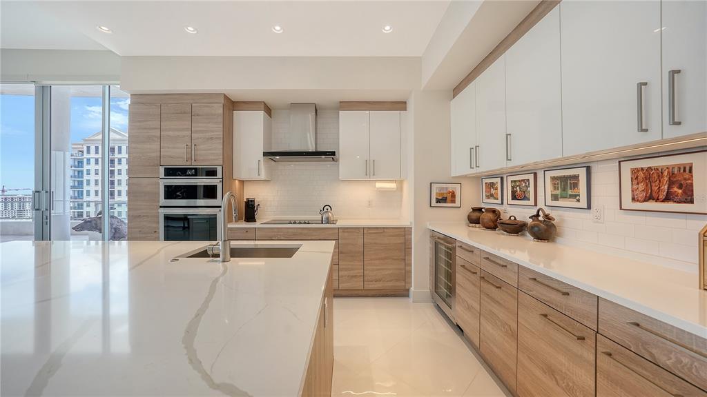 111 South Pineapple Avenue, Unit 1210 Sarasota, FL 34236 - Photo 33 of 54 a kitchen with stainless steel appliances a sink a stove a refrigerator cabinets and a window