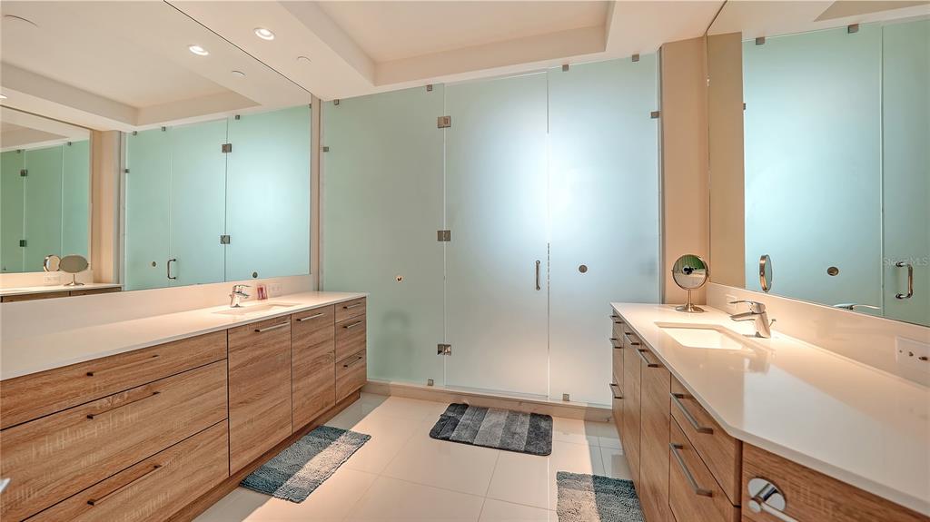 111 South Pineapple Avenue, Unit 1210 Sarasota, FL 34236 - Photo 41 of 54 a spacious bathroom with double vanity and mirrors