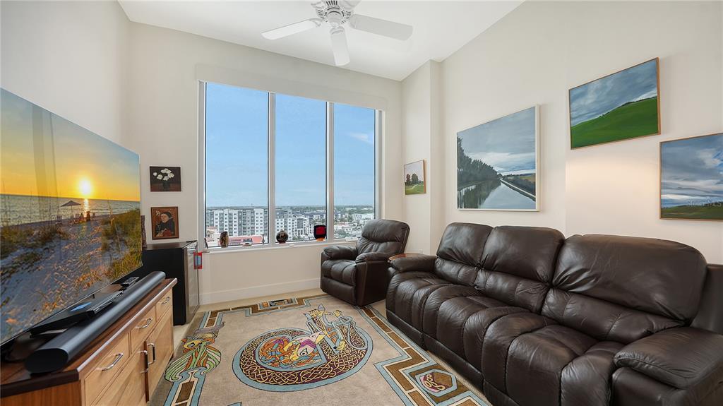 111 South Pineapple Avenue, Unit 1210 Sarasota, FL 34236 - Photo 43 of 54 a living room with furniture and a flat screen tv