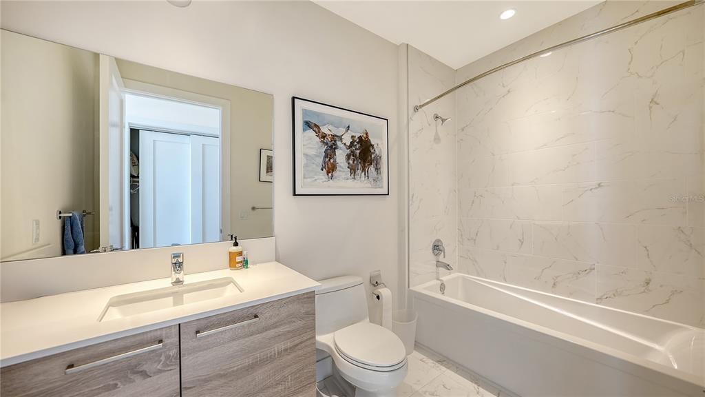111 South Pineapple Avenue, Unit 1210 Sarasota, FL 34236 - Photo 44 of 54 a bathroom with a granite countertop sink a toilet and bathtub