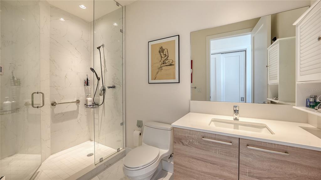 111 South Pineapple Avenue, Unit 1210 Sarasota, FL 34236 - Photo 46 of 54 a bathroom with a sink toilet and shower
