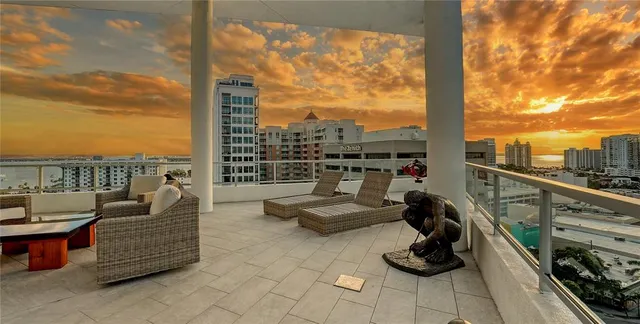 a view of roof deck with seating area and roof