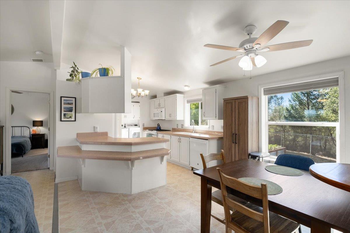7155 Stewart Mine Road Placerville, CA 95667 - Photo 11 of 68 a view of a dining room with furniture window and outside view