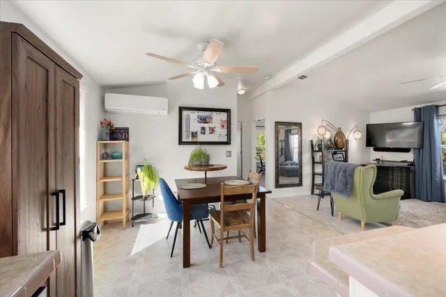 a living room with furniture and a dining table