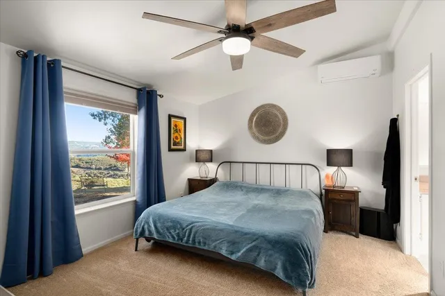 a room with a bed and a television