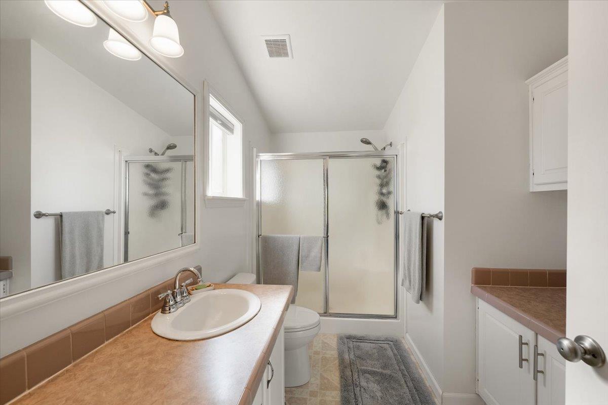 7155 Stewart Mine Road Placerville, CA 95667 - Photo 20 of 68 a bathroom with a sink a toilet and a mirror