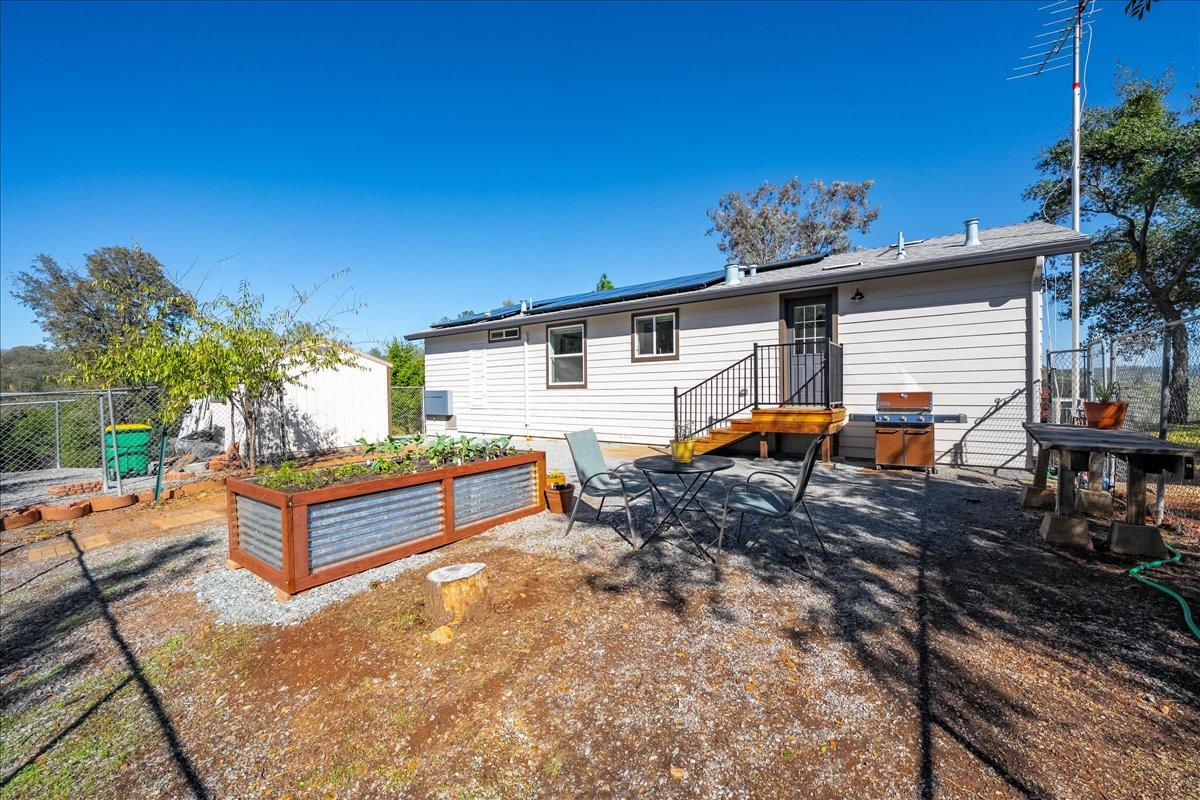 7155 Stewart Mine Road Placerville, CA 95667 - Photo 25 of 68 a backyard of a house with barbeque oven table and chairs