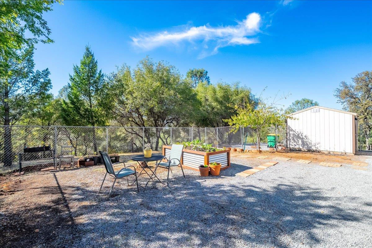 7155 Stewart Mine Road Placerville, CA 95667 - Photo 26 of 68 a backyard of a house with table and chairs