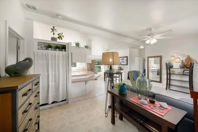a living room with furniture a piano and a flat screen tv