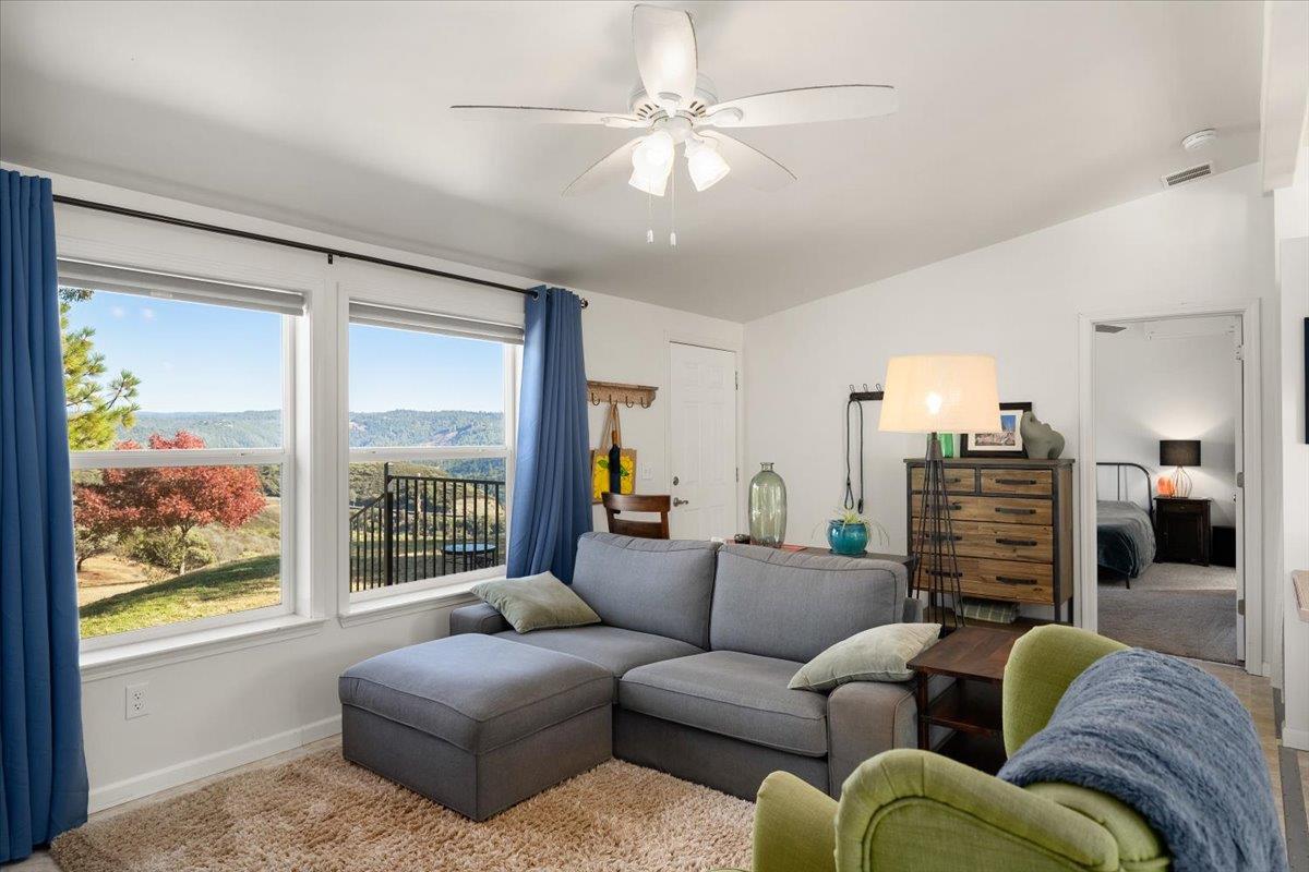 7155 Stewart Mine Road Placerville, CA 95667 - Photo 7 of 68 a living room with fireplace furniture and a large window