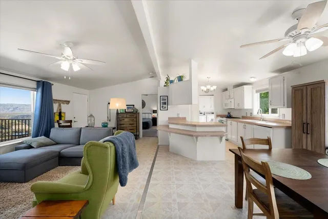 a living room with furniture a dining table and kitchen view