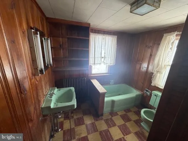a kitchen with cabinets and chair