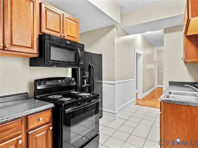 a kitchen with stainless steel appliances granite countertop a stove microwave and refrigerator