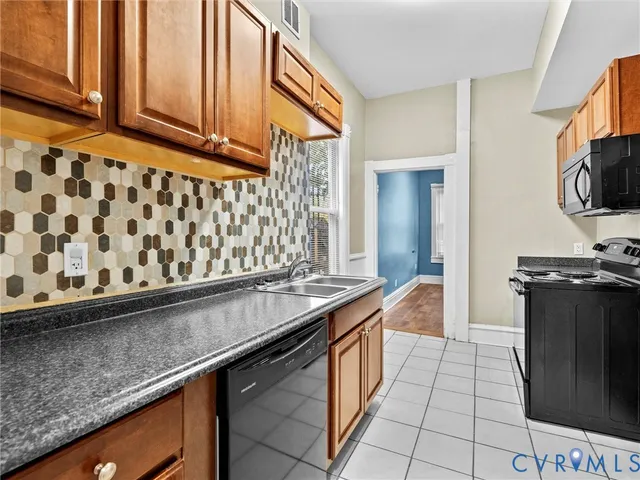 a kitchen with stainless steel appliances a sink stove and cabinets