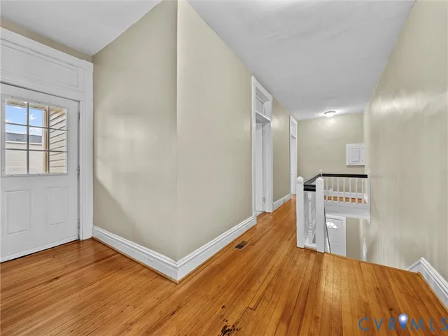 a view of a hallway with wooden floor